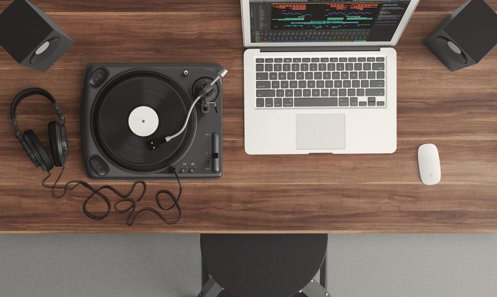pexels photo 164716 Top view of a music production desk with a laptop and turntable setup for modern audio production.