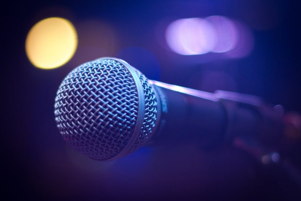 pexels photo 164879 An artistic close-up of a microphone with blurred bokeh lighting, perfect for music themes.
