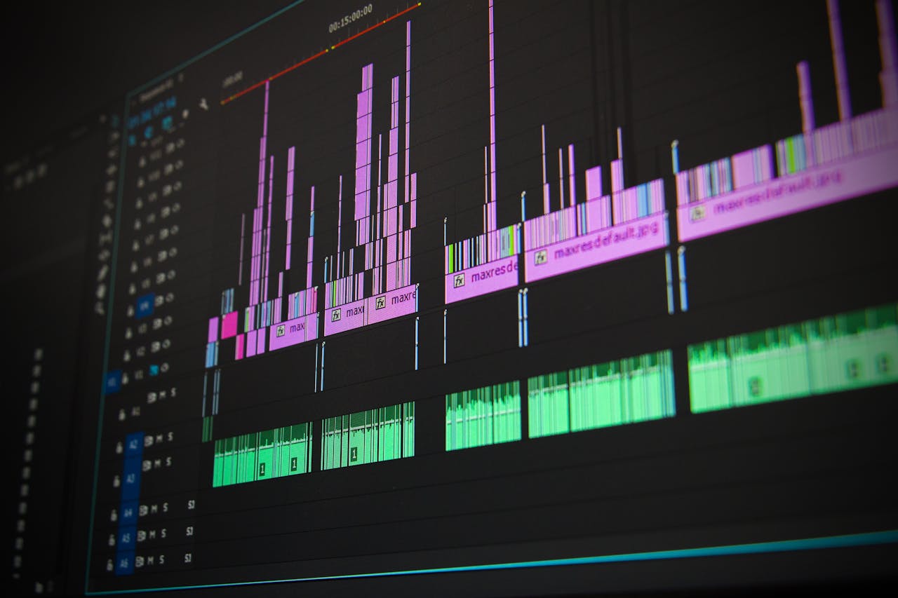 hero-img-01 Close-up of a professional audio and video editing software interface with waveform displays.